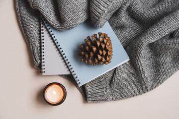 Cozy Morning Routine with Gray Knit Sweater, Notebooks, and Candles. Hygge Flat Lay for Autumn and...