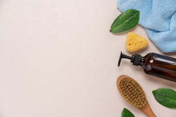 Natural Skincare Products and Body Massage Brush on Light Beige Background Top View