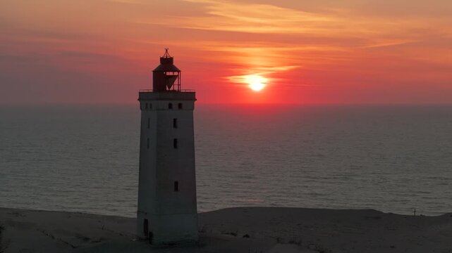 Aerial view of the giant sand dunes with the famous lighthouse on the top of a hill. Rubjerg Knude Lighthouse, , North SeaRubjerg , Sunset at the lighthouse Rubjerg Knude Fyr near Lokken in Denmark. 