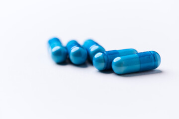 Amino acids capsules on bright background. Soft focus. Close up. Copy space.	