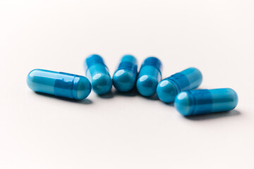Amino acids capsules on bright background. Soft focus. Close up. Copy space.	