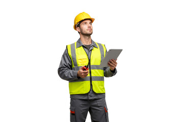 Skilled construction worker in safety gear holding tablet and radio, looking up for inspiration and new ideas at worksite