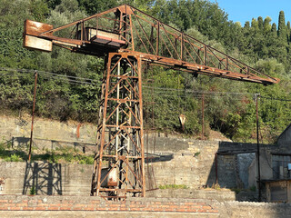 Buildings of old factory. Ruins and rusty structures. Old dilapidated building and nature.
