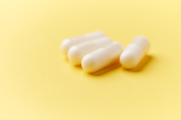 Creatine tablets on paper background. Soft focus. Close up. Copy space.	