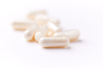 Creatine tablets on paper background. Soft focus. Close up. Copy space.	