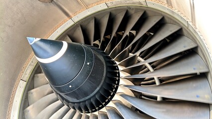 Close-up of shiny aircraft engine fan blades, showcasing precision engineering, aerodynamic design,...