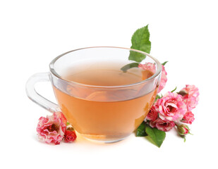 Tasty rose tea in glass cup and flowers isolated on white