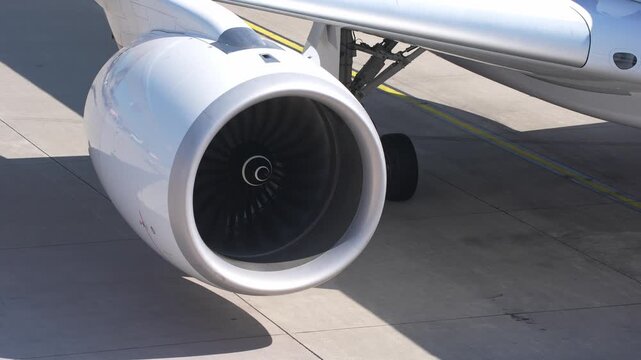 Close-up of jet engine of passenger airplane slowing down with smoke at Swiss Airport Z&uuml;rich Kloten on a hot summer day. Movie shot August 11th, 2025, Zurich Kloten, Switzerland.