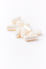 Creatine tablets on paper background. Soft focus. Close up. Copy space.	