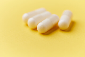 Creatine tablets on paper background. Soft focus. Close up. Copy space.	