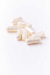 Creatine tablets on paper background. Soft focus. Close up. Copy space.	