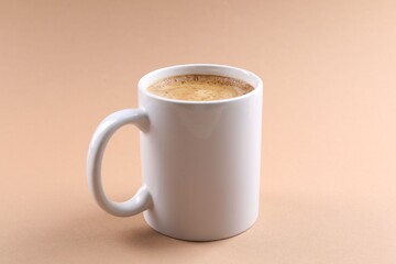 Aromatic coffee in cup on beige background, closeup. Mockup for design