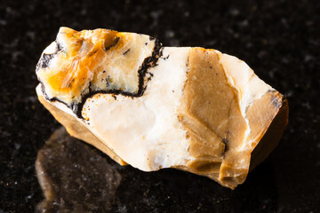 sample of raw common opal mineral on black