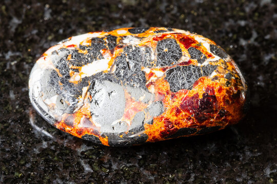 tumbled franklinite and zincite rock on black