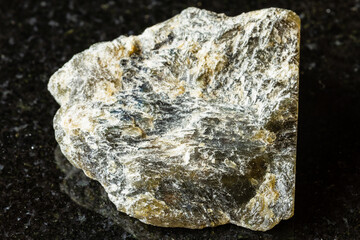 sample of raw dark labradorite mineral on black
