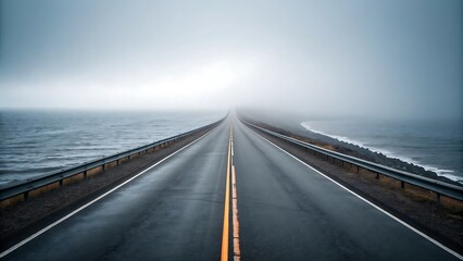 Fototapeta premium Coastal Highway Disappearing into Fog a Road to Nowhere Alongside the Ocean on a Moody Day Exploring the Coastline on a Roadtrip