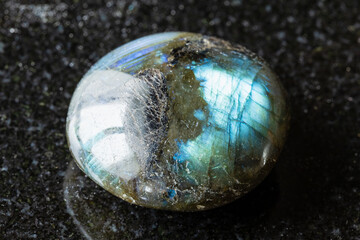 sample of polished labradorite mineral on black