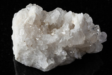 sample of druse of clear quartz rock on black