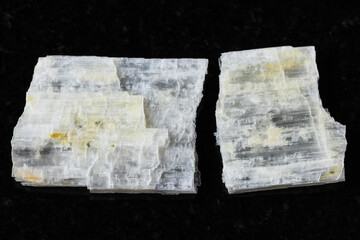 sample of raw eudidymite mineral on black granite