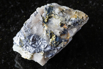 raw molybdenite and chalcopyrite in rock on black