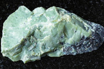 sample of raw teyskiy jade mineral on black