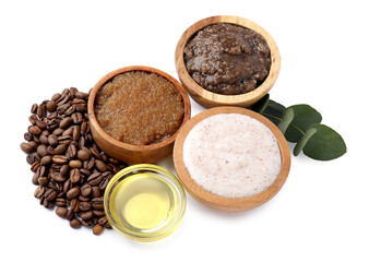 Natural body scrubs in bowls, coffee beans, oil and eucalyptus branch isolated on white, above view