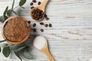 Natural body scrub in bowl and ingredients on wooden table, flat lay. Space for text