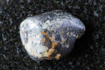 tumbled cleiophane and mushketovite rock on black