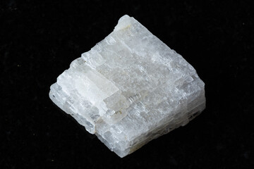 sample of raw colorless calcite mineral on black