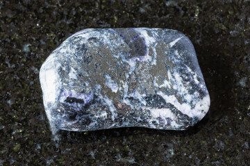 sample of tumbled antimonite mineral on black