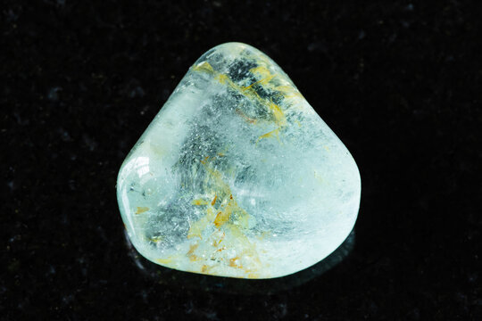 sample of polished blue topaz mineral on black