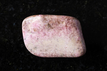 sample of polished pyroxmangite rock on black