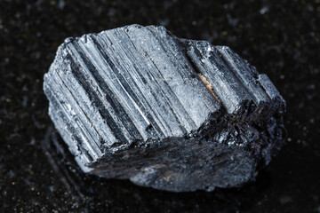 sample of raw tourmaline schorl rock on black