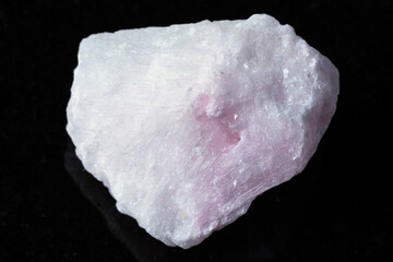 sample of raw pink aragonite mineral on black