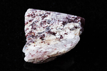 sample of raw strawberry quartz mineral on black