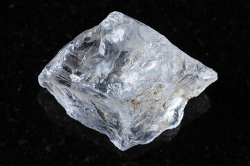 sample of rough rock crystal mineral on black