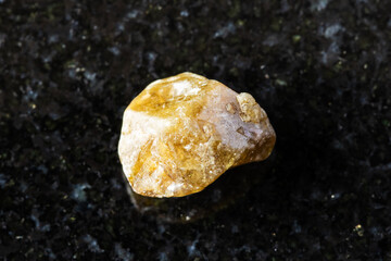 rough single grossular garnet crystal on black