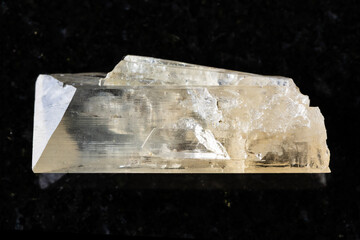 sample of raw danburite mineral on black granite