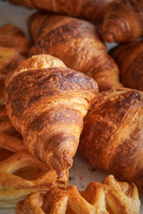Fresh buttery croissants stacked on a plate for breakfast and brunch enjoyment