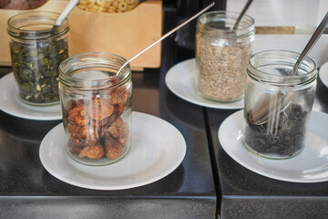 Assortment of small topping jars arranged on plates for sampling