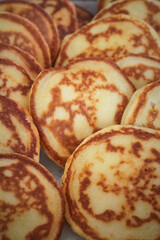 Close arrangement of small pancakes showcasing texture and golden edges