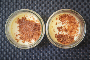 Two ramekins with caramelized tops prepared as baked custard desserts