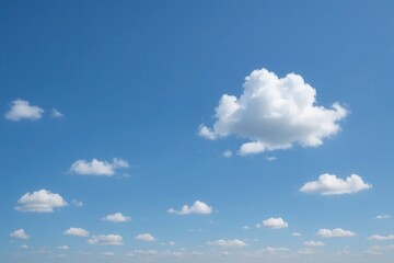 Obraz premium A serene expanse of blue sky dotted with fluffy white clouds, symbolizing tranquility and endless possibilities