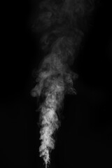 Dense white smoke or steam rising upwards on black background in dramatic style. Swirling, writhing...