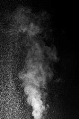Cloud of white dust particles floating in dark air on black background. Swirling, writhing smoke to overlay on your photos. evoking mystery, motion, and atmosphere