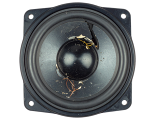 A damaged black speaker, isolated on a white background, symbolizing themes of broken electronics, sound issues, or junk.