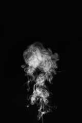 Wisps of white smoke swirling and curling in the air, monochrome photographic style, isolated on black background, concept of mystery and motion