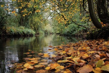 Colorful autumn leaves float on the surface of a tranquil river surrounded by lush greenery in a peaceful natural setting