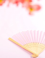 Pink paper fan on light pink background