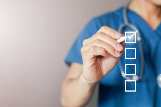 close up young general practitioner hand use stylus pen to check box on medical chekclist or opd record to read and diagnose and assess about patient's symptom for healthy and lifestyle concept